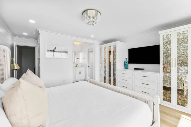 a bedroom with a large bed and a flat screen tv