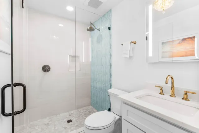 a bathroom with a sink toilet and shower