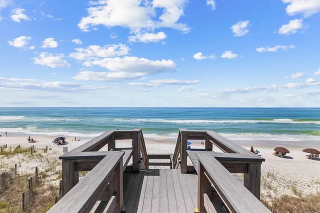 a view of a balcony with wooden floor and outdoor seating