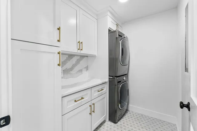 a utility room with cabinets washer and dryer
