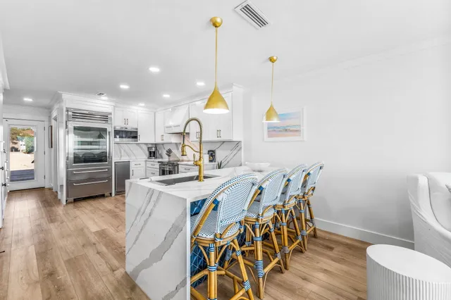 a very nice looking room with kitchen island furniture and a wooden floor