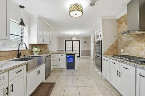 a bathroom with a granite countertop sink a toilet and shower