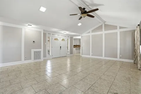 a kitchen with granite countertop a stove a sink and a refrigerator