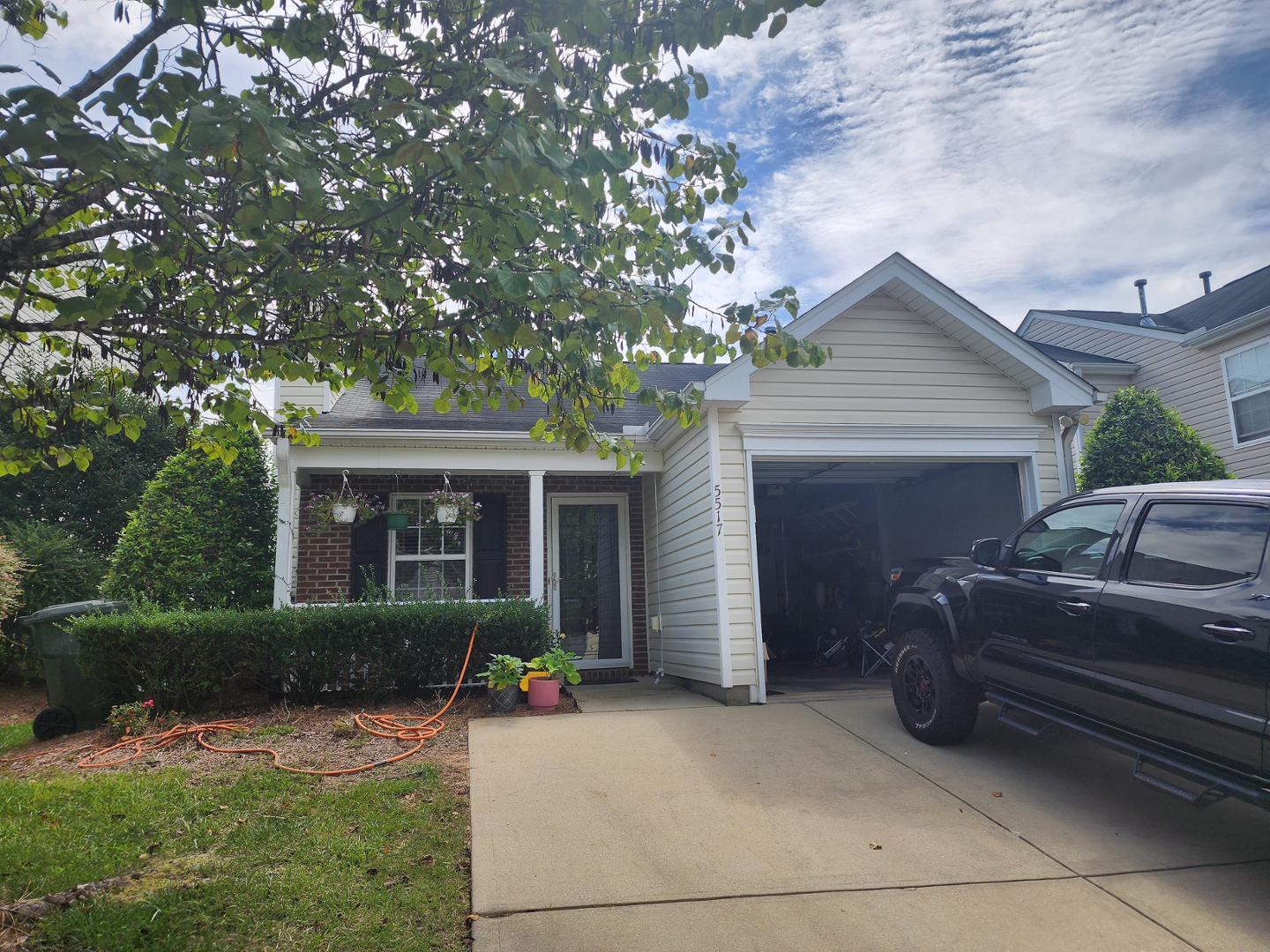 a house view with a sitting space fire pit and outdoor space