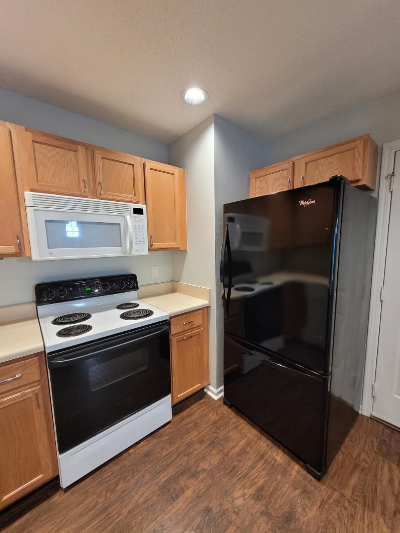 5517 Roan Place Raleigh, NC 27613 - Photo 11 of 35 a kitchen with a stove and a microwave