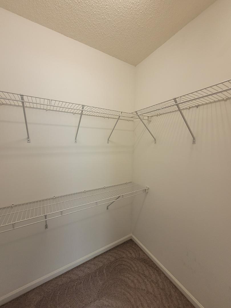 5517 Roan Place Raleigh, NC 27613 - Photo 13 of 35 a view of a room with racks on the wall