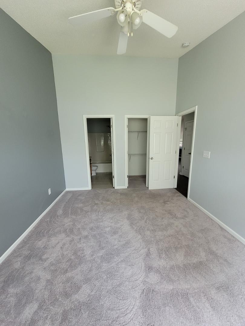 5517 Roan Place Raleigh, NC 27613 - Photo 14 of 35 a view of an empty room with chandelier fan