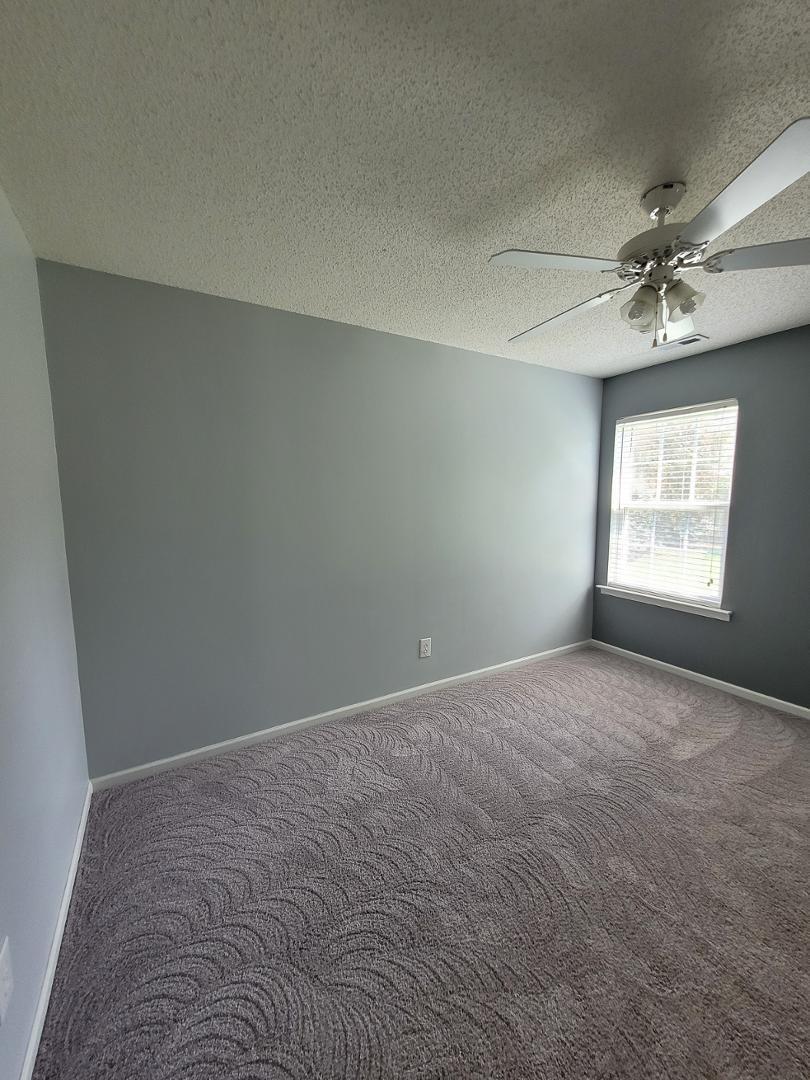 5517 Roan Place Raleigh, NC 27613 - Photo 20 of 35 an empty room with windows and fan