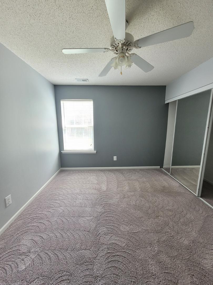 5517 Roan Place Raleigh, NC 27613 - Photo 22 of 35 an empty room with a window and a fan