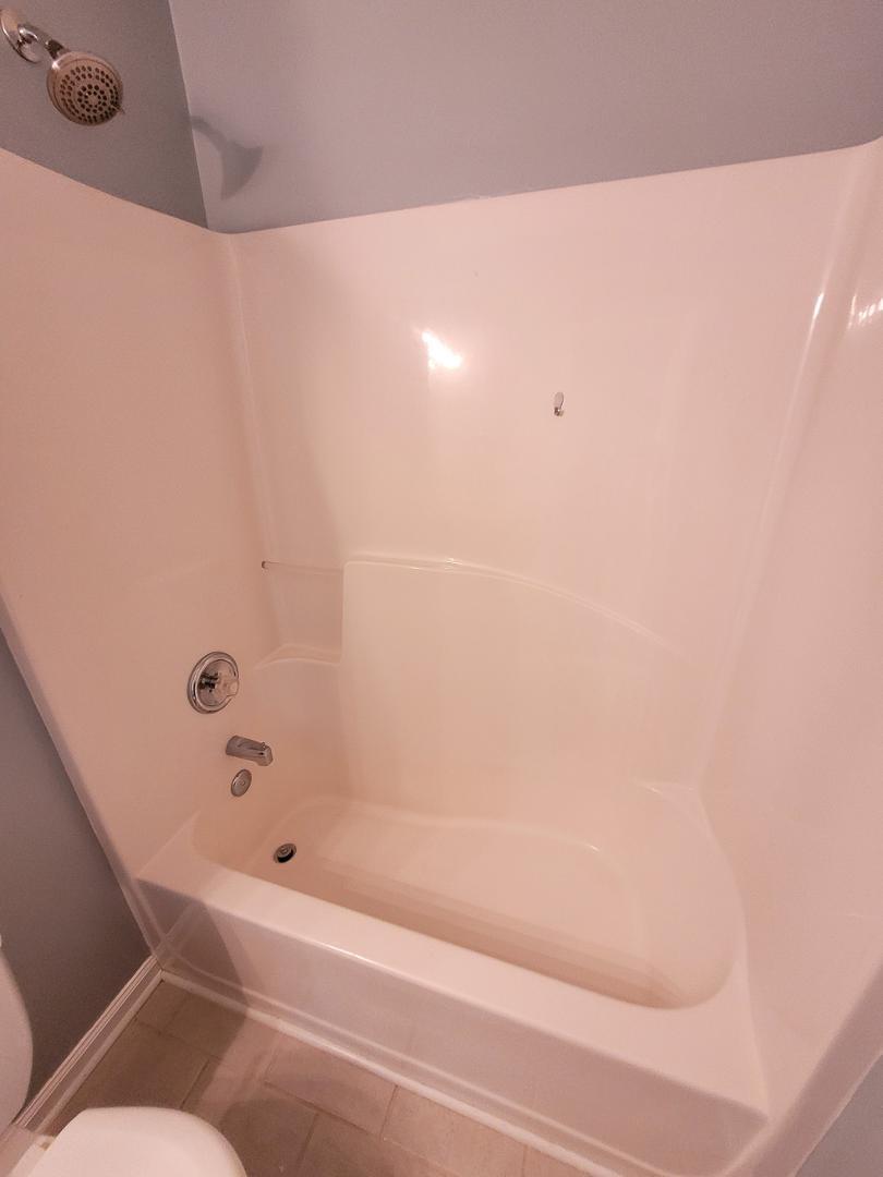 5517 Roan Place Raleigh, NC 27613 - Photo 27 of 35 a bathroom with a bathtub and shower