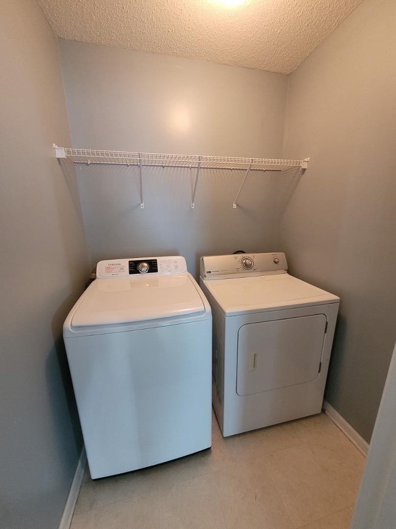 5517 Roan Place Raleigh, NC 27613 - Photo 28 of 35 a utility room with dryer and washer