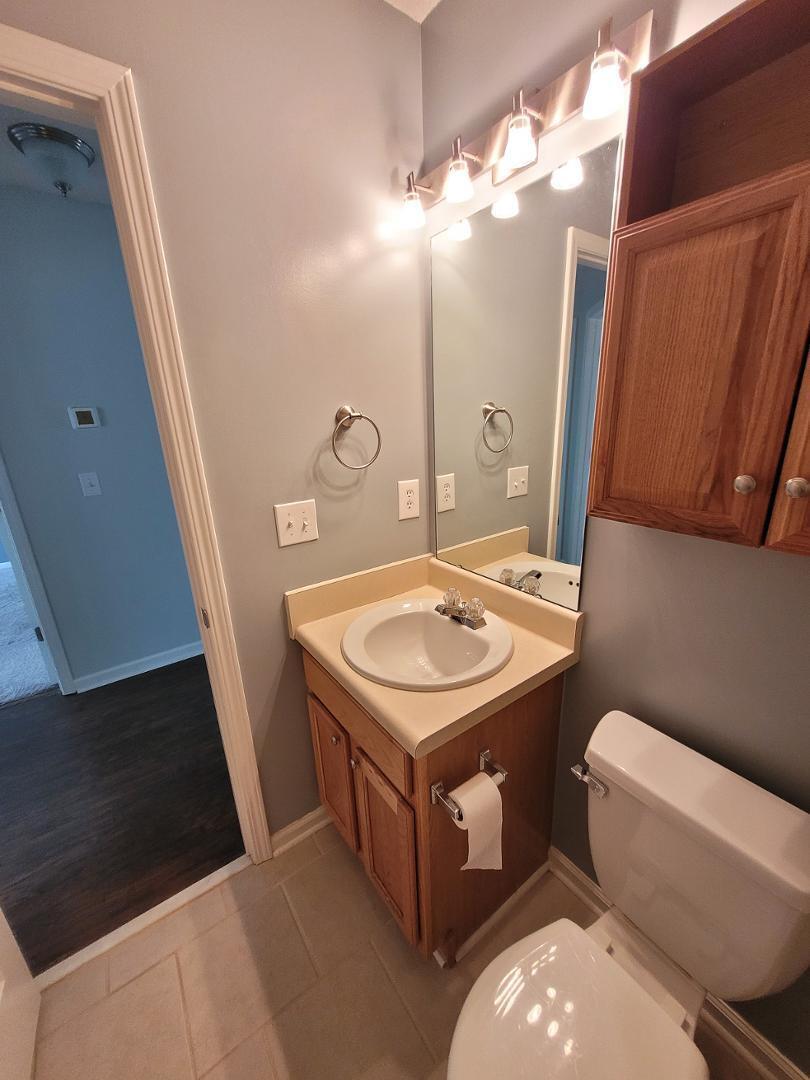 5517 Roan Place Raleigh, NC 27613 - Photo 29 of 35 a bathroom with a sink toilet and mirror