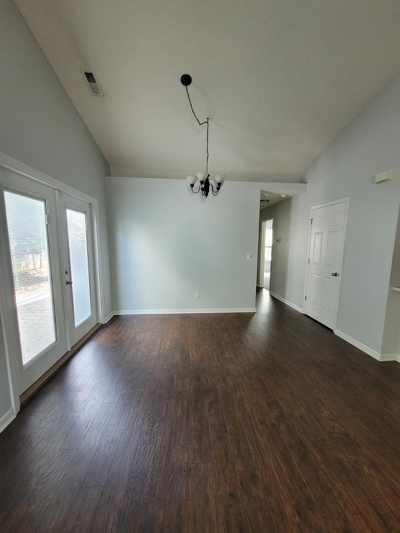 5517 Roan Place Raleigh, NC 27613 - Photo 6 of 35 an empty room with wooden floor and windows