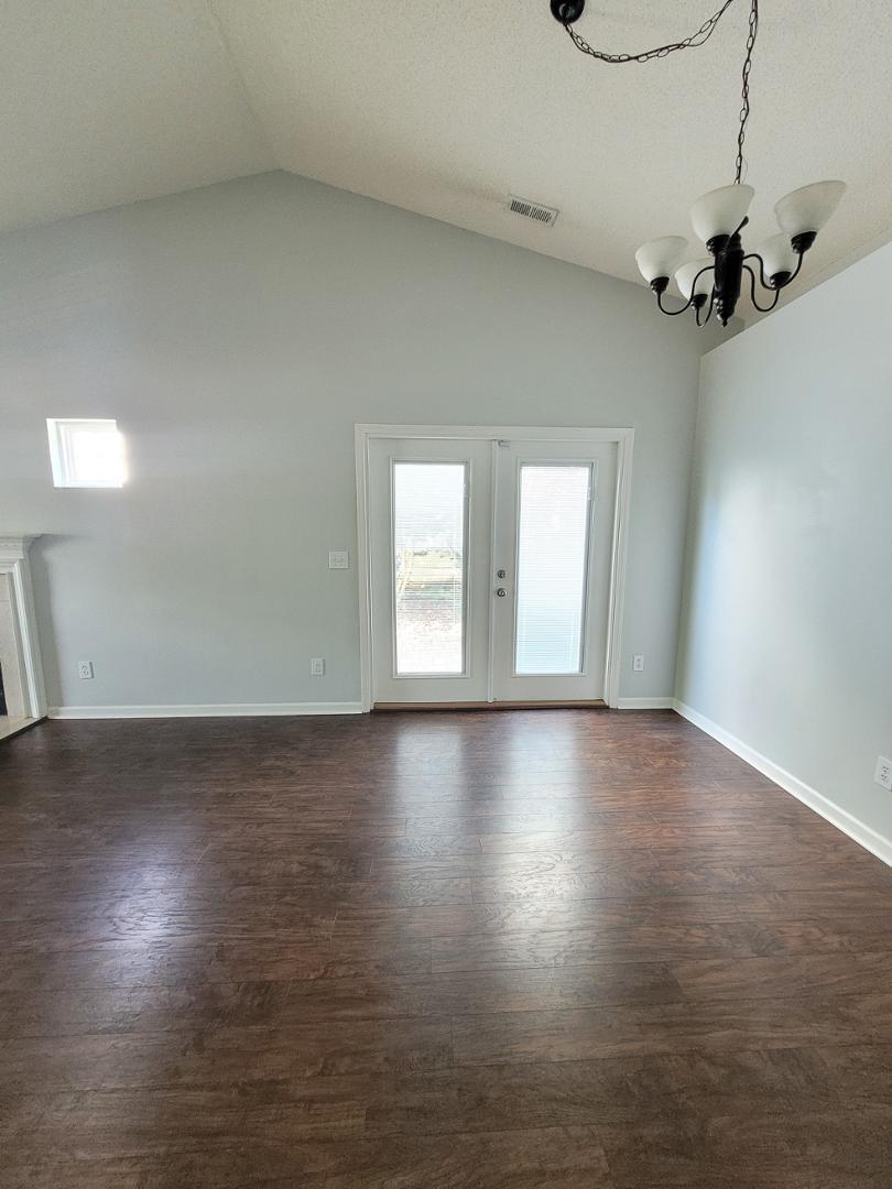 5517 Roan Place Raleigh, NC 27613 - Photo 7 of 35 an empty room with wooden floor and windows