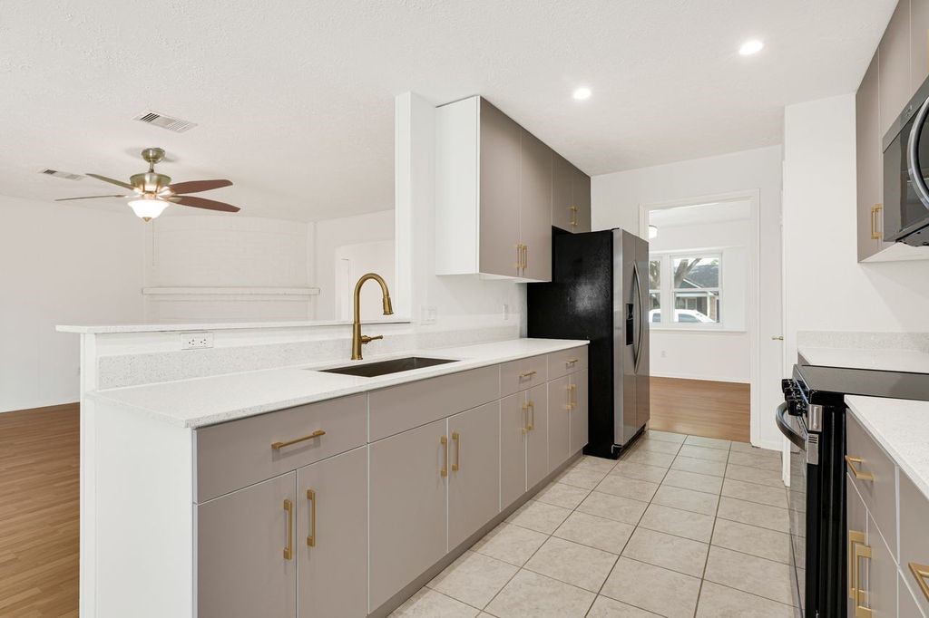 4518 Seneca Street Pasadena, TX 77504 - Photo 12 of 26 a kitchen with a sink appliances and cabinets