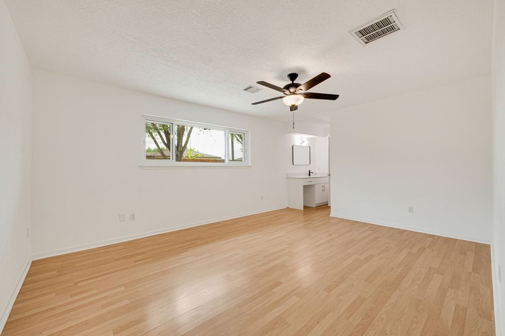 4518 Seneca Street Pasadena, TX 77504 - Photo 16 of 26 wooden floor in an empty room with a window