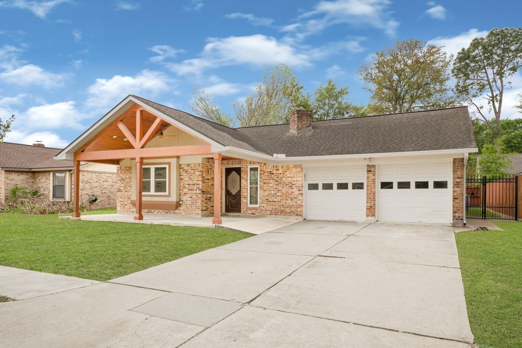 4518 Seneca Street Pasadena, TX 77504 - Photo 2 of 26 a front view of a house with a yard and garage