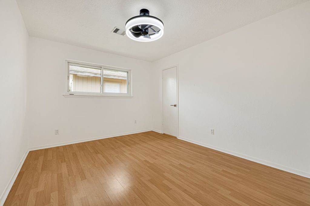 4518 Seneca Street Pasadena, TX 77504 - Photo 22 of 26 a view of a room with wooden floor and ceiling fan