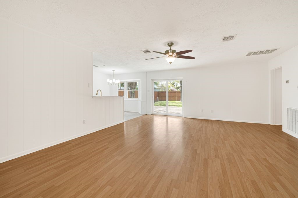 4518 Seneca Street Pasadena, TX 77504 - Photo 8 of 26 a view of an empty room with a window and wooden floor