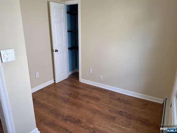 an empty room with wooden floor