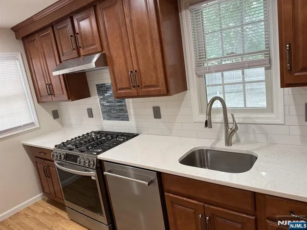 a kitchen with a sink stove and cabinets
