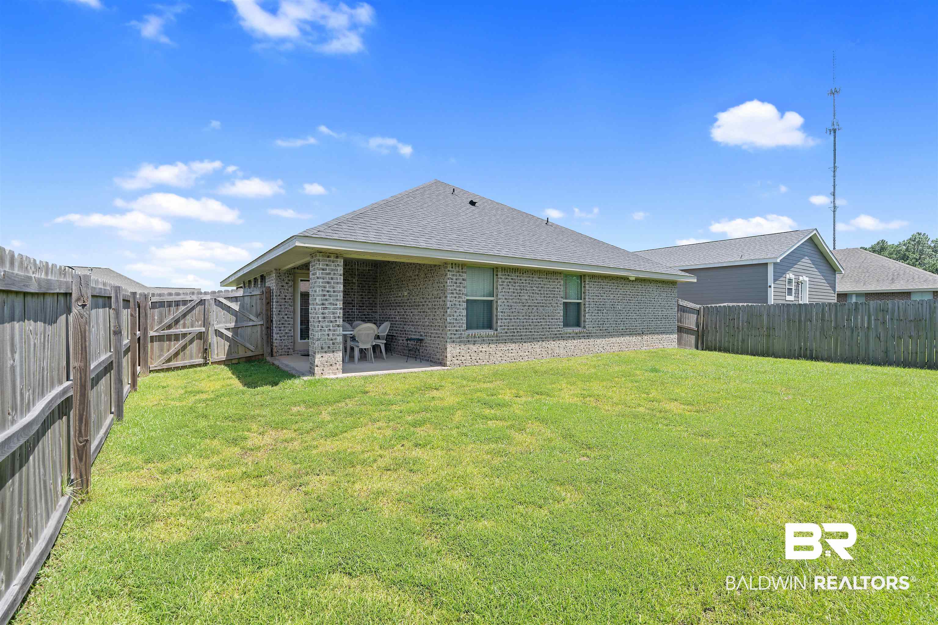 8823 Allay Lane Foley, AL 36535 - Photo 17 of 18 Back of property with a yard and a patio area