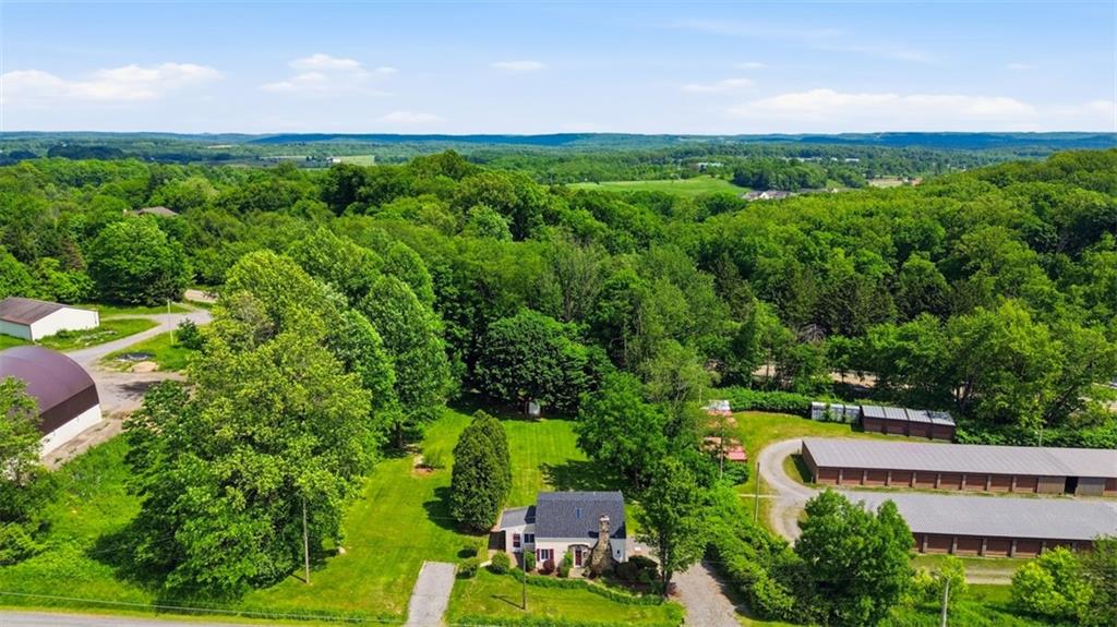 123 Cemetery Road Slippery Rock, PA 16057 - Photo 18 of 33 This stunning aerial view showcases the property's expansive, park-like setting and picturesque countryside views. No neighbors on either side of you. You will have a great time enjoying your .68 acres.