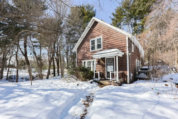 a view of a house with snow on the road