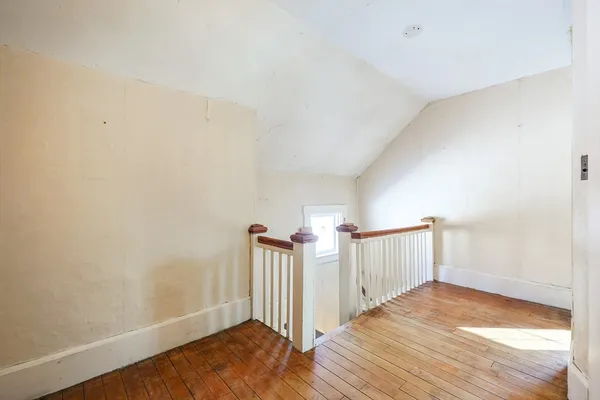 a view of a room with wooden floor