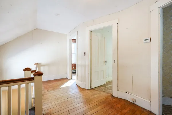 a view of a room with wooden floor