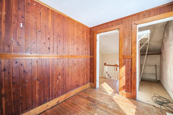 a view of a livingroom with wooden floor and entryway