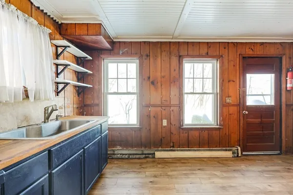 a view of a kitchen with a sink and cabinets