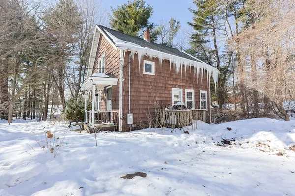 a view of a house with snow on the road