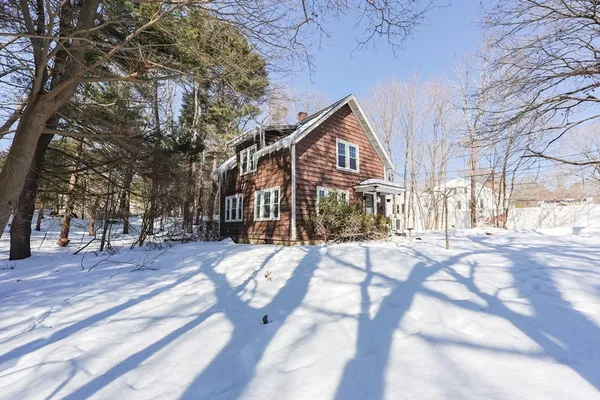 a view of a house with a yard covered in snow