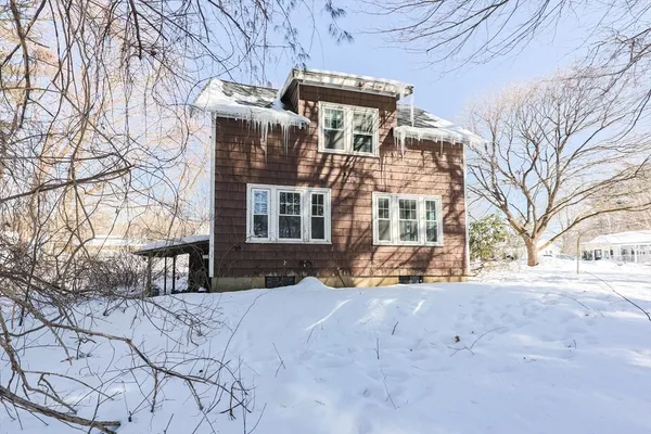 a view of a building with a yard covered in snow