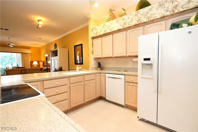 a kitchen with granite countertop white cabinets and white appliances