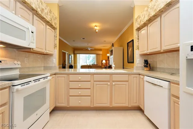 a kitchen with white cabinets and white appliances