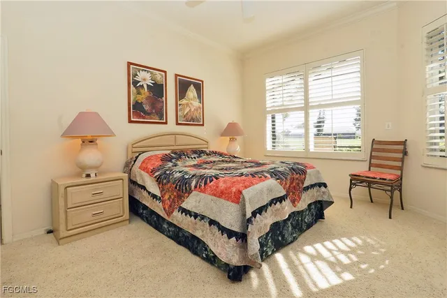 a bedroom with a bed and a lamp on table