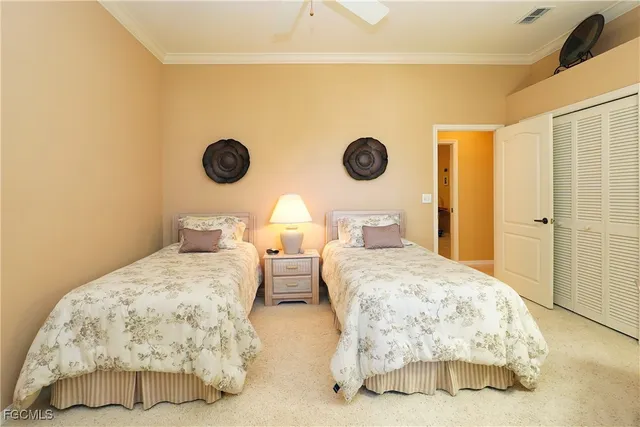 a bedroom with bed and a chandelier