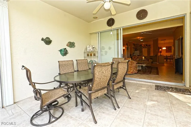 a dining room with furniture and a floor to ceiling window