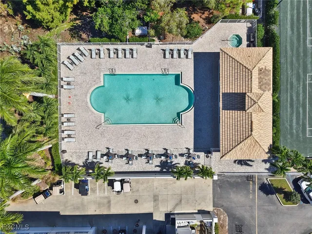 an aerial view of a house with outdoor space and seating area