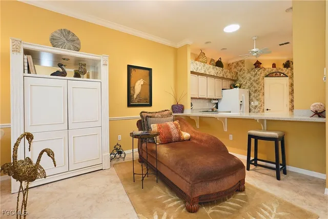 a living room with furniture a rug and white walls