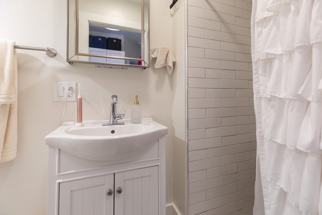 100 H Street, Unit 1 Boston, MA 02127 - Photo 11 of 12 a bathroom with a sink and a mirror