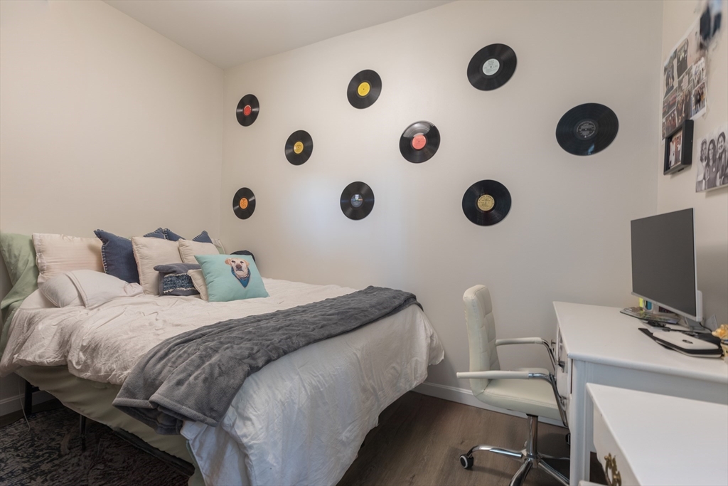 100 H Street, Unit 1 Boston, MA 02127 - Photo 7 of 12 a bedroom with a bed and a chair