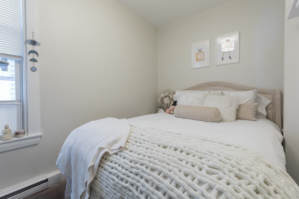 100 H Street, Unit 1 Boston, MA 02127 - Photo 8 of 12 a bedroom with a bed and a window