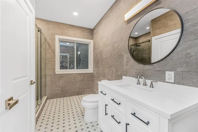 a bathroom with a sink a mirror and a toilet