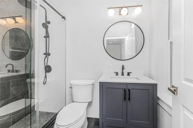 a bathroom with a toilet a sink and a mirror