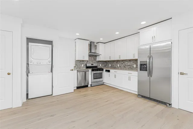 a kitchen with a refrigerator a sink and cabinets