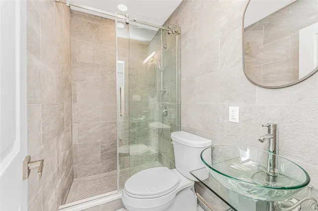 a bathroom with a toilet a sink and a mirror