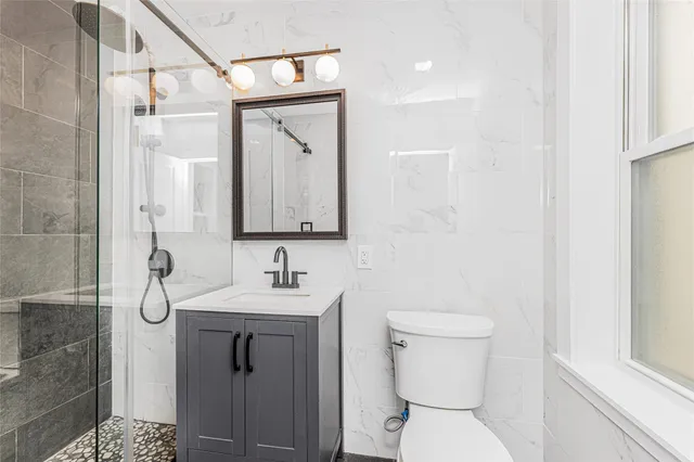 a bathroom with a toilet sink and mirror